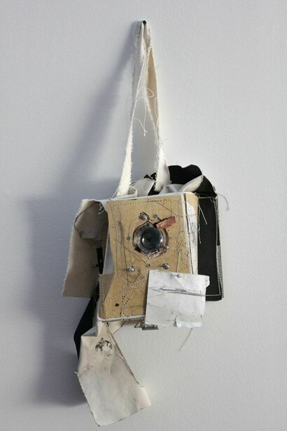Greg Smith, Linoleum Camera, 2013, Linoleum, canvas, gesso, thread, paper, graphite, pushpin, lens, copper, epoxy, digital cameral parts, wood, hardware. Courtesy: Susan Inglett Gallery, NYC.