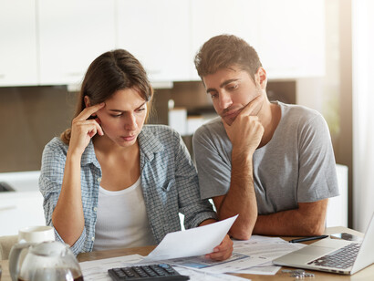 A young couple reviews their family budget together