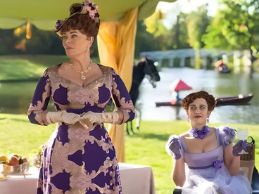 Lady Portia Featherington from Bridgerton wearing a richly patterned purple gown while accompanied by her daughter, symbolizing the extravagance of maximalist style