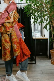 Mulher carrega tecidos estampados. O mundo da moda está passando por uma transição que está trazendo as estampas de volta  