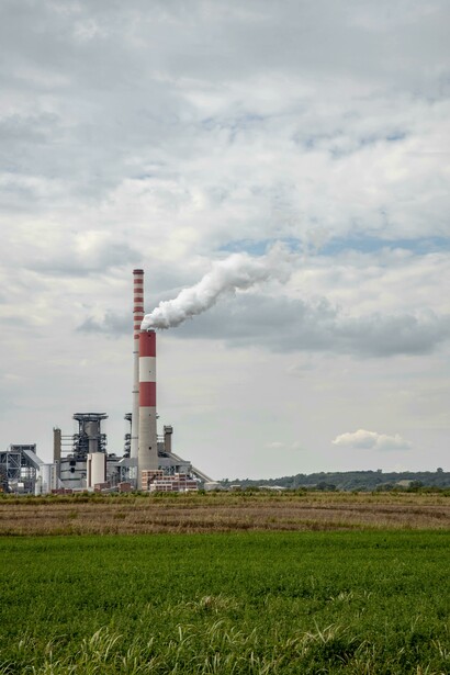 Smoke billows from factory chimneys showcasing industrial activity 