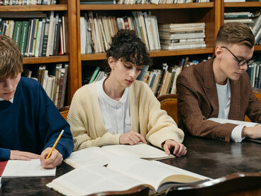 A group of students studying together in the library