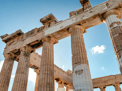 Columns of the Parthenon in sunlight among ancient ruins, Athens, Greece