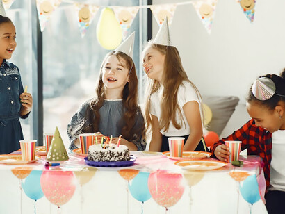 The birthday girl and her friends share in the jubilant celebration, creating a moment of pure joy and youthful exuberance