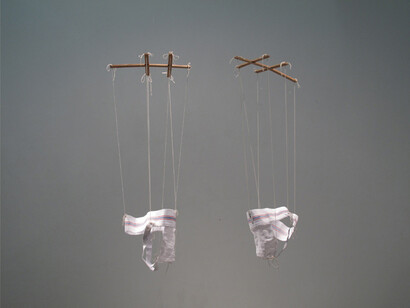 Anna Campbell, Coquettes (s,l), 2013, two jockstraps sized small and large, wood, twine, 1 x 1 x 3 in each