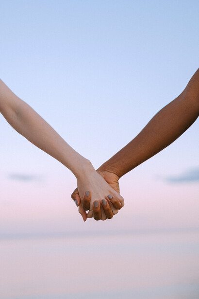 Two people holding hands