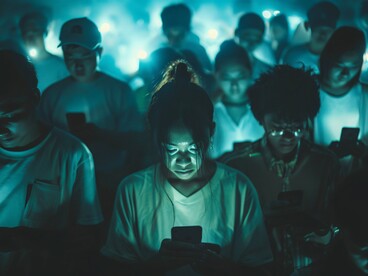 A scene of people fixated on their smartphones, continuously scrolling