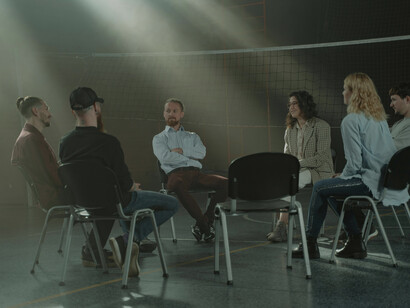 In an OCD group therapy setting, individuals build confidence by sharing their stories and engaging in public speaking to support mental health advocacy