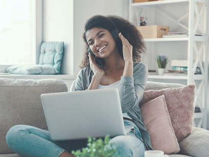 With a smile on her face, this remote worker enjoys the flexibility of working from home, empowered by AI tools that streamline her tasks and boost productivity