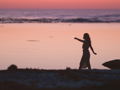 With each joyful step on the sandy shore, she celebrates the transformative journey of finding her true essence amidst the beauty of nature