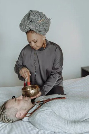 A man and a woman relaxing on a bed, experiencing Ayurvedic healing and comfort