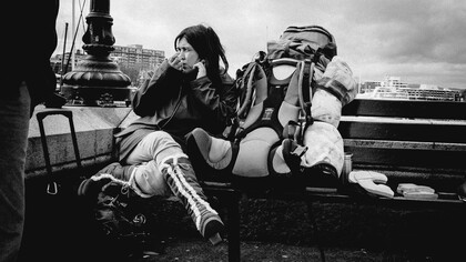 The woman pauses for a moment on a bench, reflecting on the deep connections she’s made during her solo travels to every corner of the globe