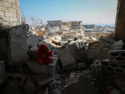 A stuffed bear amidst the ruins, innocence lost