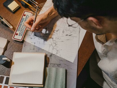 Top view of an architecture student engaged in creative thinking while developing an architectural project