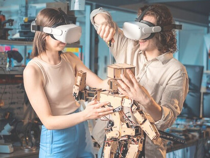 Young man and woman in protective glasses conducting robotics experiments in a laboratory, showcasing human creativity and the synergy between humans and machines