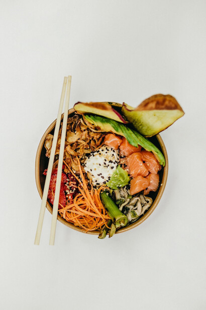 Chopsticks resting delicately on a bowl of delectable food.