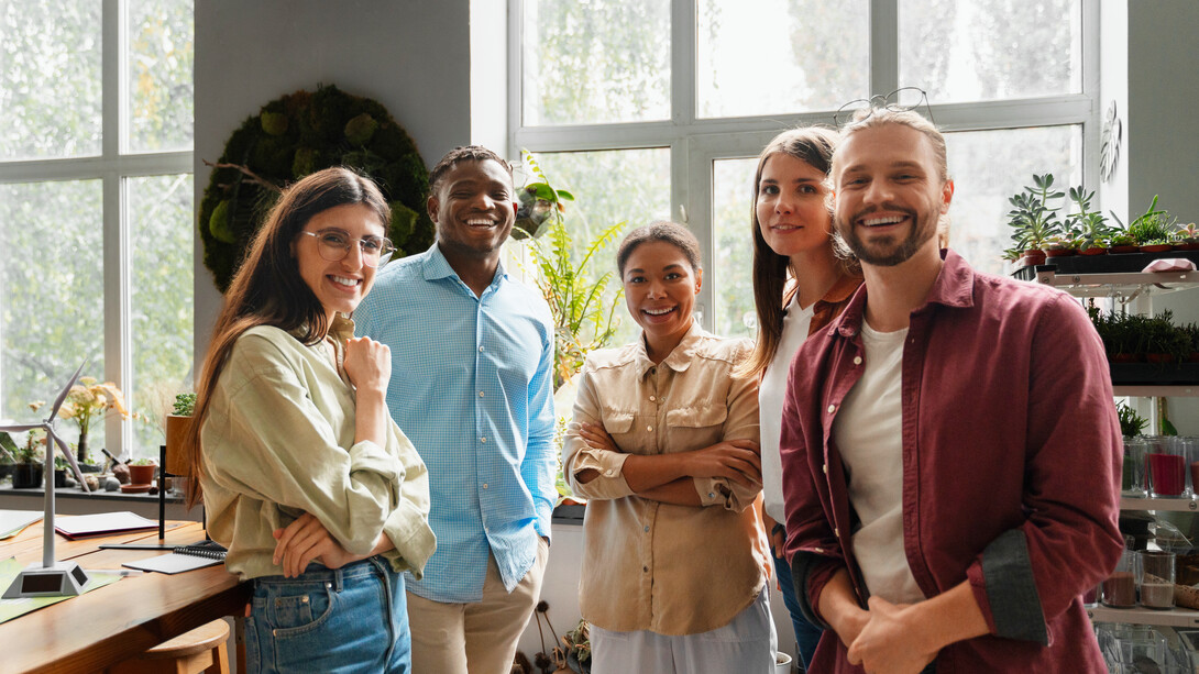 Colleagues brainstorm innovative solutions for reducing carbon emissions, highlighting how sustainability is sparking fresh ideas across industries