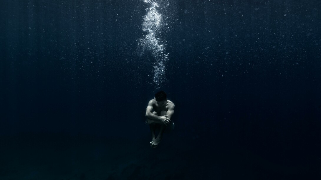 Man sitting underwater