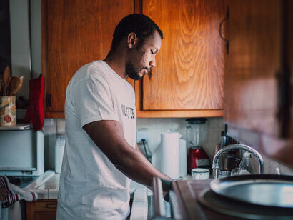 A dedicated volunteer helping a senior clean their home, fostering connection and compassion through acts of kindness
