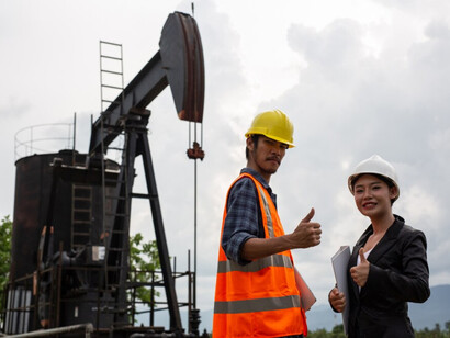 A Chinese advisor and a middle eastern energy worker at an oil extraction site reflect the expanding investment 