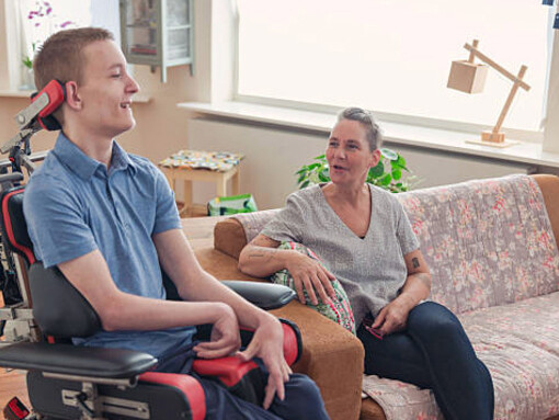 A mother assists her son living with ALS