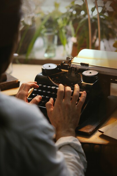 A person crafting poetry on a typewriter 