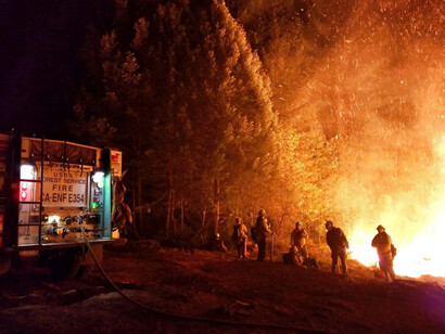 The Camp Fire was later shown to have been sparked by the PG&E-owned Caribou-Palermo transmission line, firefighters shown fighting the fire in 2018, Paradise California, USA