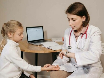 Doctor examining child for medical history