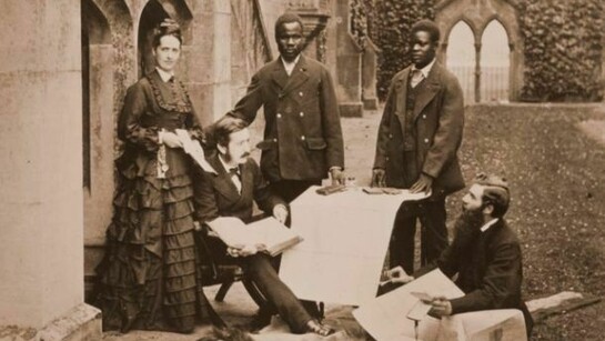 Agnes and Thomas Livingstone, daughter and son of David Livingstone, Abdullah Susi, James Chuma and Rev Horace Waller at Newstead Abbey, Nottingham, with the journals, maps and plans made by the late David Livingstone, 1874