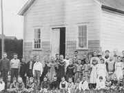 The Little Red School House in California, USA from long ago, with women as the teachers of different ages of children