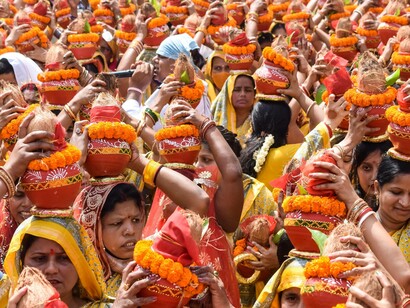 Women with kalash on head during a festival in India