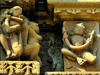 Carved relief of Gandharvas, divine dancers, on the walls of Chaturbhuja Temple, Khajuraho, India, showcasing their celestial elegance and rhythmic artistry