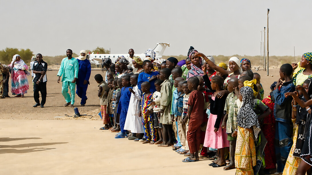 Crowds in Gao, Mali, form a guard of honour for humanitarian workers who arrived by plane in April to assess local needs