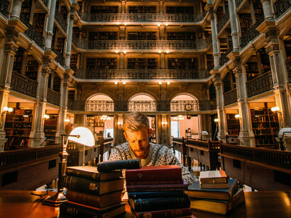 A young man studying in Library George Peabody, Baltimore, Maryland