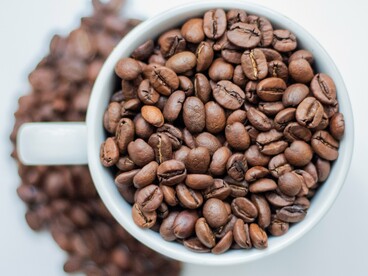 A cup filled with roasted coffee beans, symbolising the foundation upon which Japan built its celebrated coffee culture