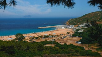 A breathtaking view of Tangier's vibrant beach in Morocco and surrounding landscape under a clear blue sky
