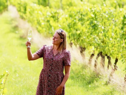 A woman sampling wine from one of Great Britain's best vineyards