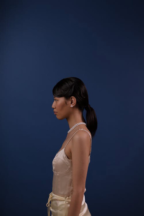 Graceful elegance meets timeless allure in this captivating pearl-adorned ensemble, embodying the resilience of fashion amidst global challenges and the promise of a brighter economic horizon