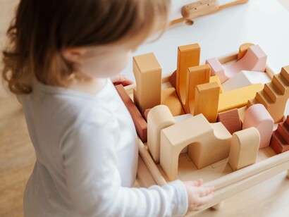 A toddler ready to relax and get creative with building blocks