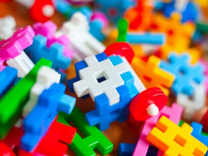 A scatter of colourful LEGO-like pieces awaiting assembly, representing the belief that life is built one small part at a time