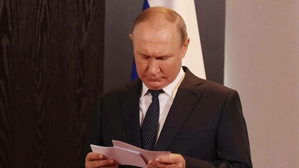 Russian President Vladimir Putin reading letters from his admirers and detractors