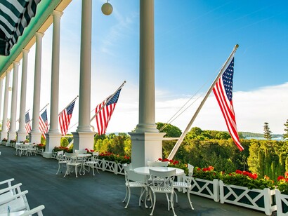 The Grand Hotel’s famous front porch lined with American flags, reflecting a proud tradition of hospitality and heritage