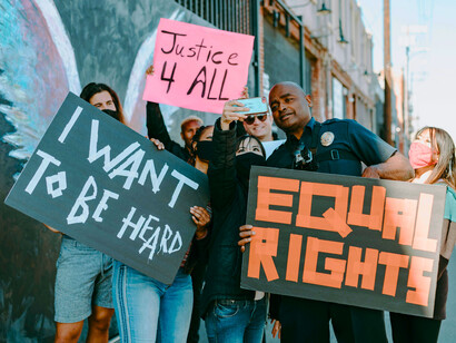 A crowd of protesters with equality signs and taking pictures, symbolising the role of digital tools in modern movements
