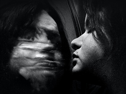 A girl stares at herself in judgment in the mirror