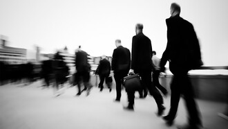 Morning commuters in London rush through the crowded streets, starting their workday
