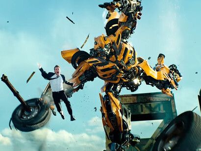 Bumblebee bursts through the chaos with Sam Witwicky airborne beside him, reflecting the controlled visual overload of Transformers: Dark of the Moon (2011)