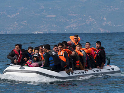 Refugees disembarking from a boat on Lesbos, Greece, amid the escalating migration crisis
