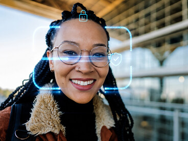 Young woman undergoing facial recognition screening at an airport security checkpoint