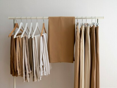 Light brown beige pants carefully arranged on hangers