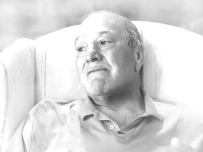 Calvin Parker sits in his chair, thinking of his history and the past UFO abduction during an interview